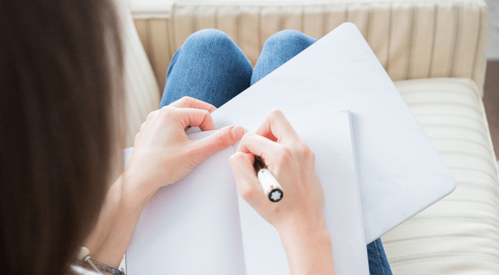 woman writing in notebook