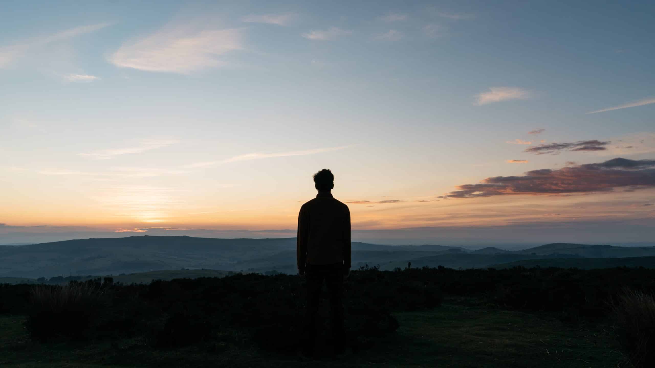 man looking at horizon | Photo by Tom Allport on Unsplash