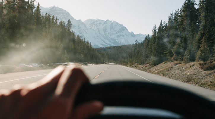 person driving into mountains