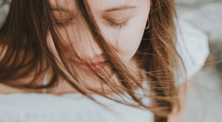 woman with hair on her closed eyes