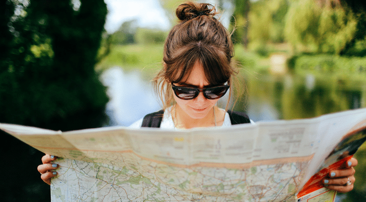 woman looking at paper map