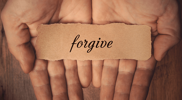 hands with forgive note