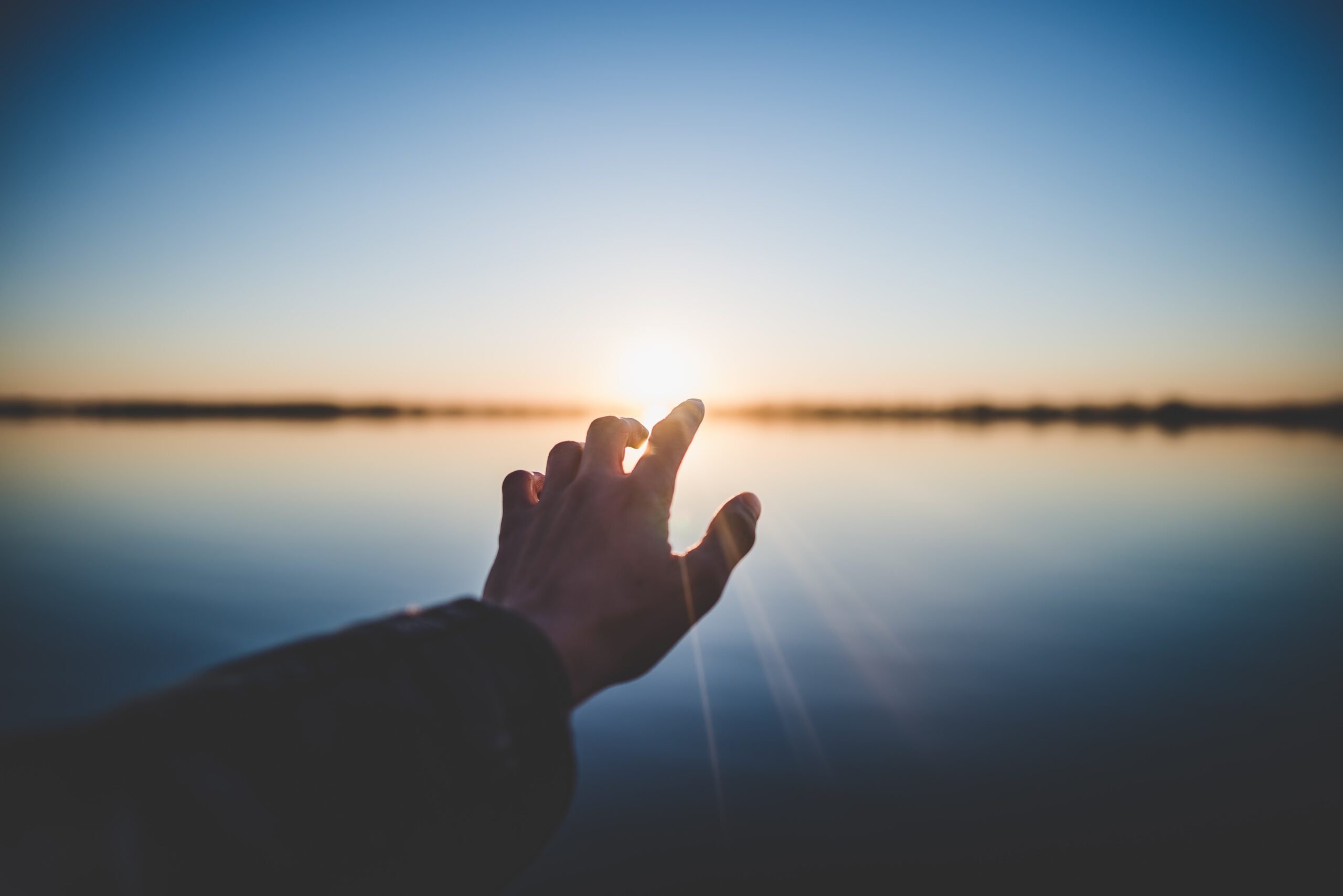 hand reaching for the sun | Photo by Marc-Olivier Jodoin on Unsplash