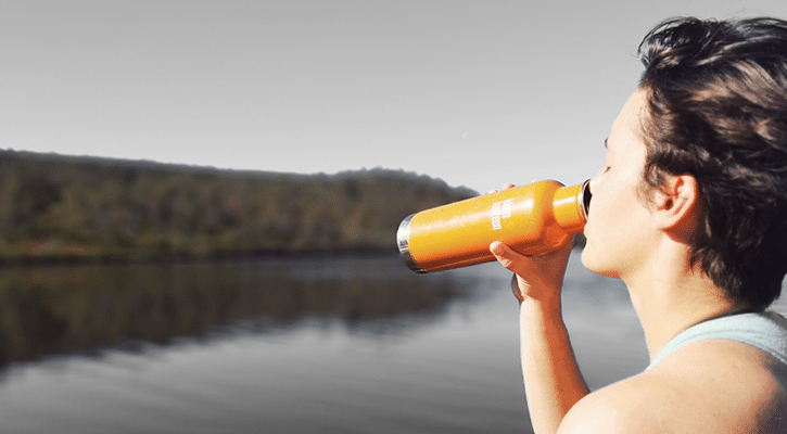 Woman drinking from water bottle