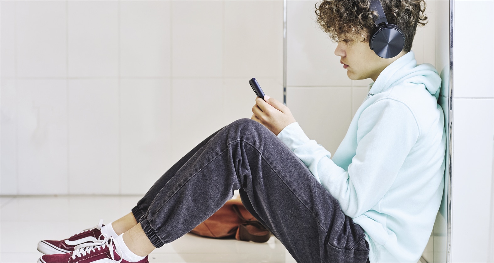 Young kid looking at his phone