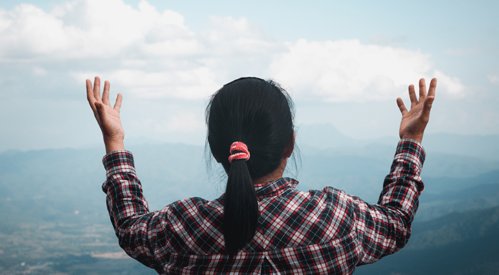 woman raising her hands.