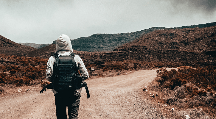 person walking a desert path