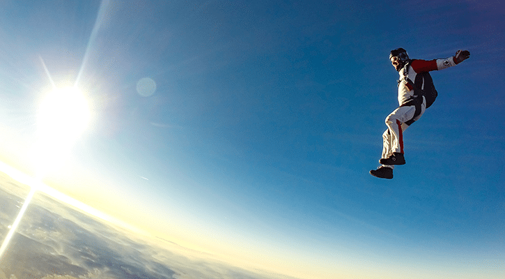 man jumping from airplane