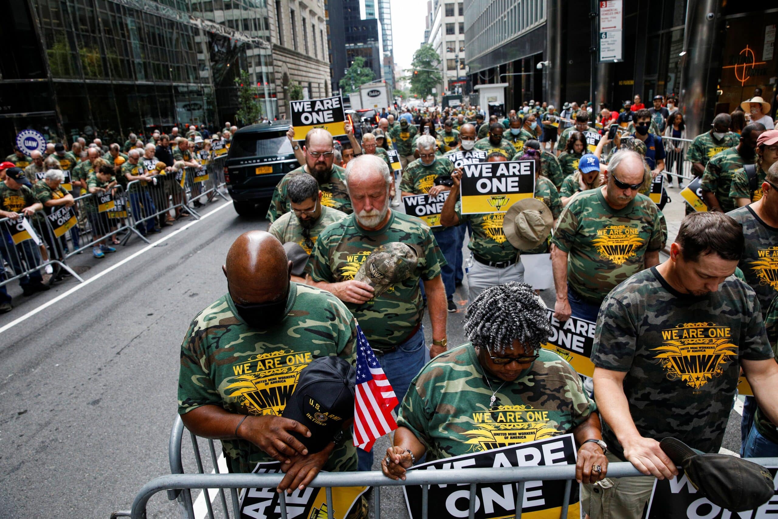 Members of United Mine Workers of America and other labor leaders bow in prayer while picketing July 28, 2021, outside BlackRock's headquarters in New York City as part of the union's strike at Warrior Met Coal Mine. (OSV News photo/Brendan McDermid, Reuters)