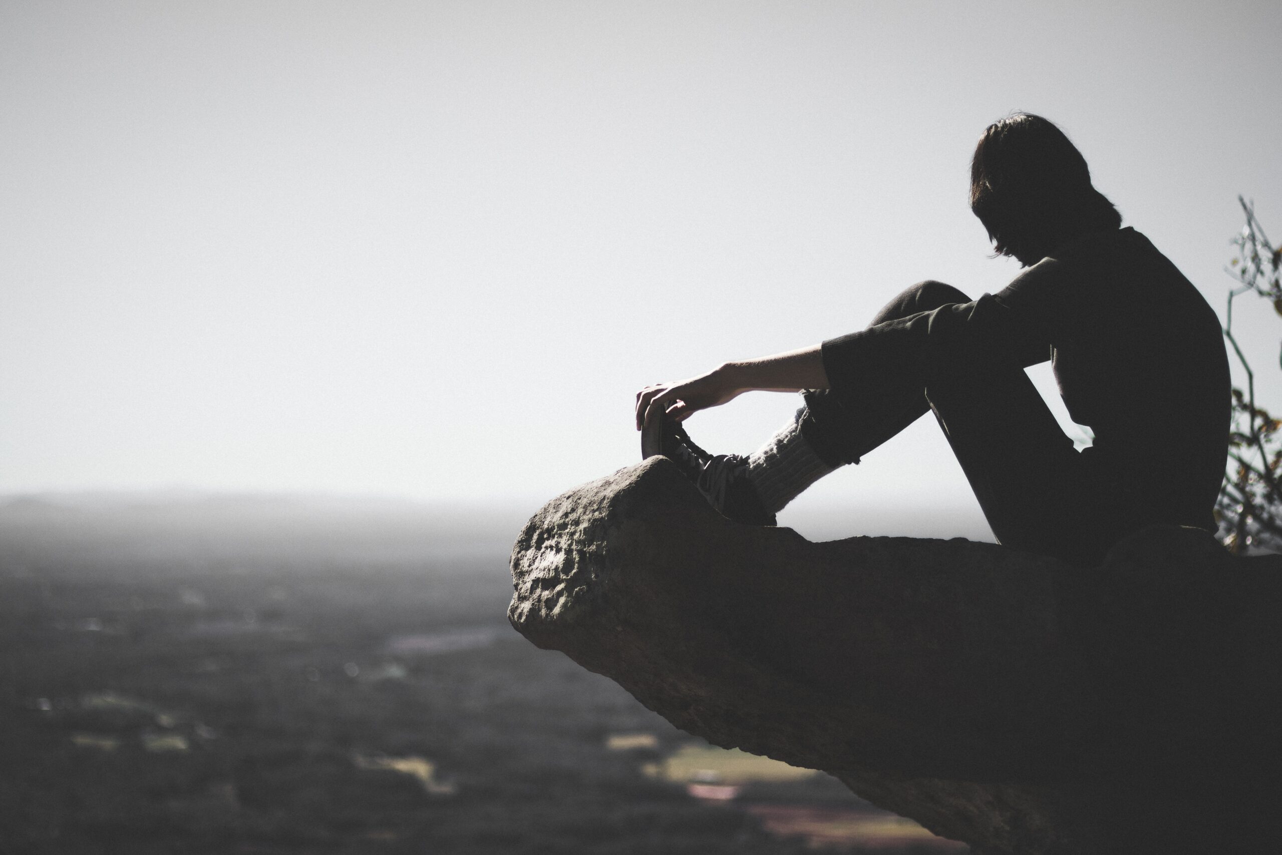 sitting on a cliff | Photo by Fil Hernandez on Unsplash