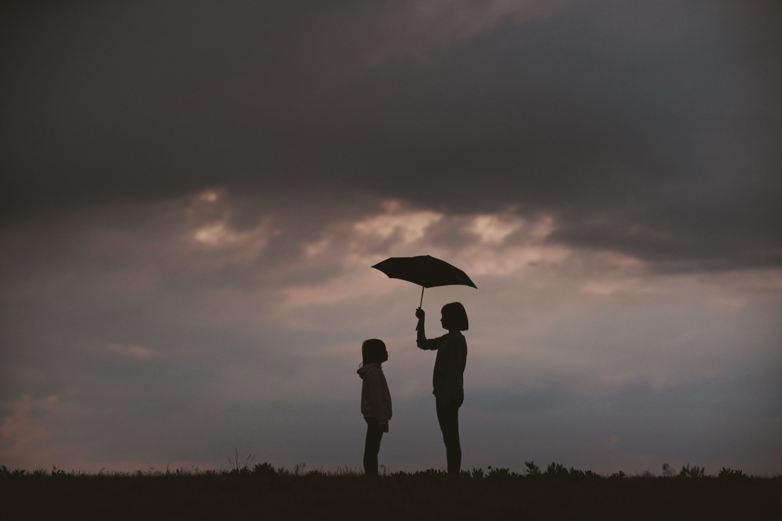 girls with umbrella | Photo by J W on Unsplash