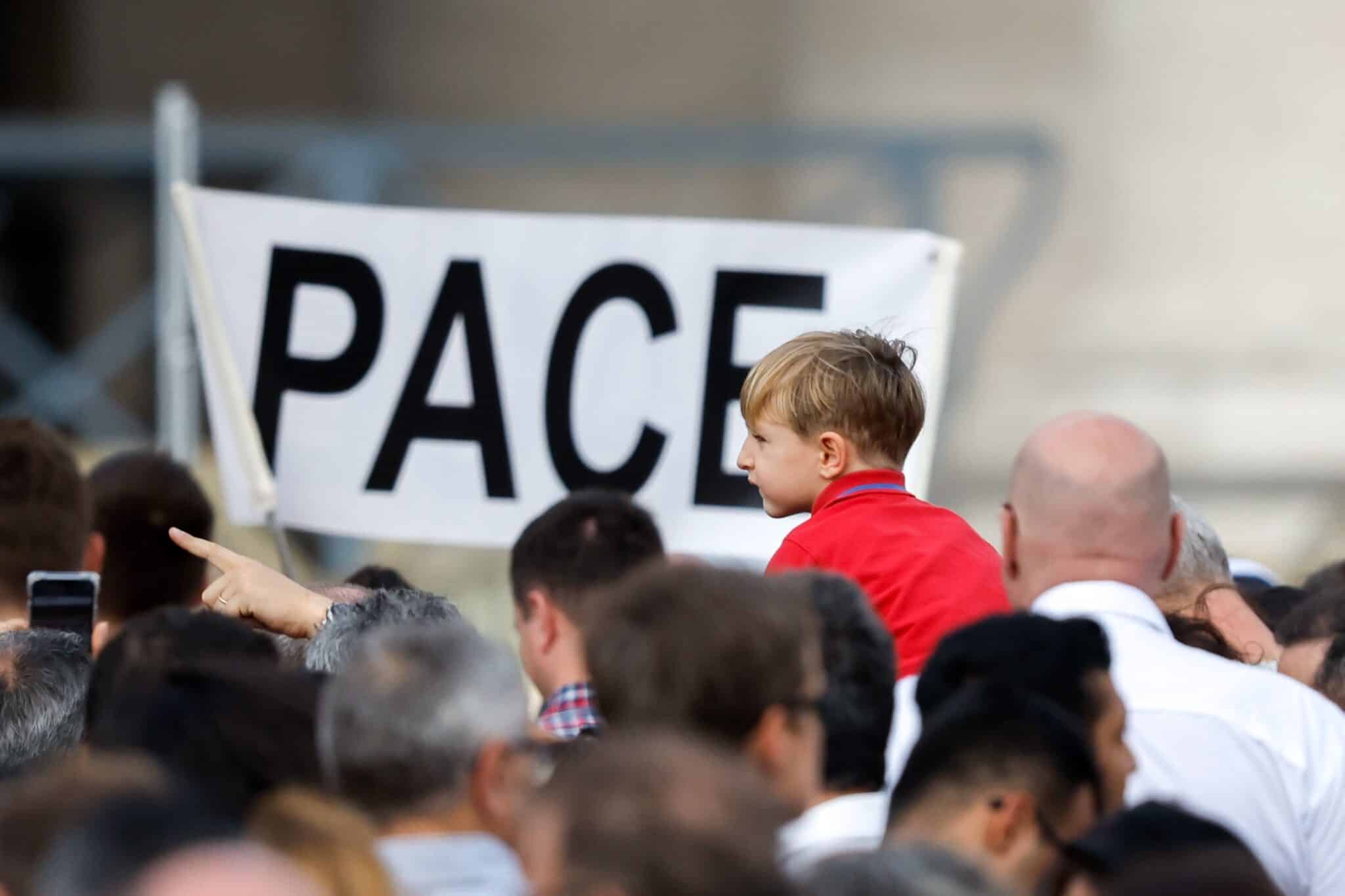 A child is near a sign that says "Pace," peace in Italian, as visitors gather to pray the Angelus with Pope Francis in St. Peter’s Square at the Vatican Oct. 29, 2023. (CNS photo/Lola Gomez)