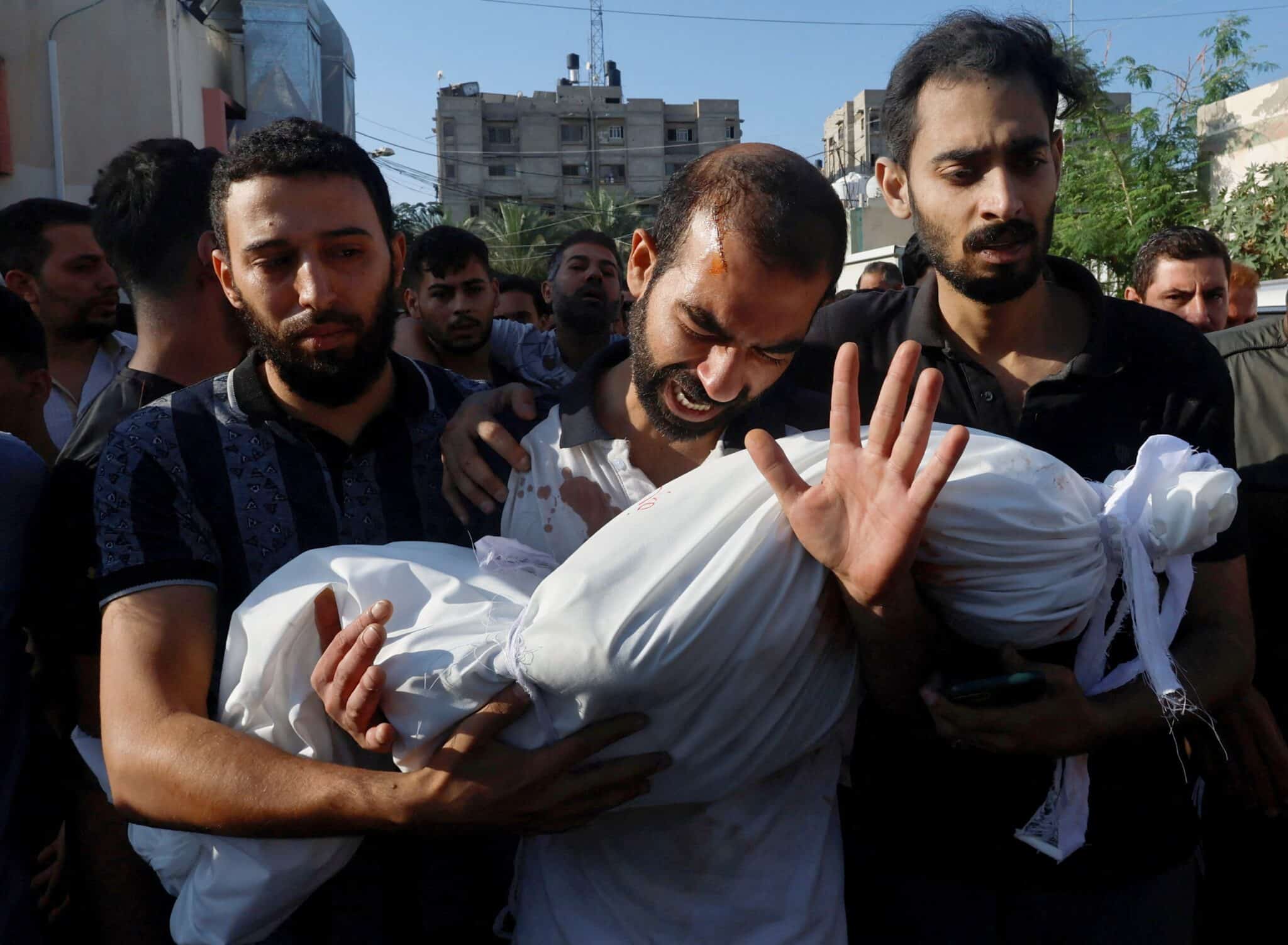 The father of Alma Al Majayda, 3, killed in an Israeli airstrike, reacts while carrying her body during the child’s funeral in Khan Younis in the southern Gaza Strip Oct. 19, 2023, amid the ongoing conflict between Israel and the Palestinian Islamist group Hamas. (OSV News photo/Mohammed Salem, Reuters)