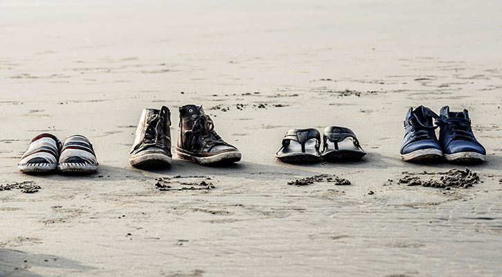 shoes on a beach belonging to a family