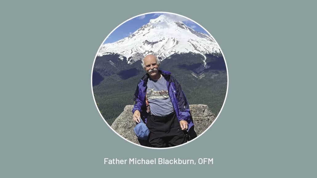 Michael Blackburn, OFM, stands in front of a mountain