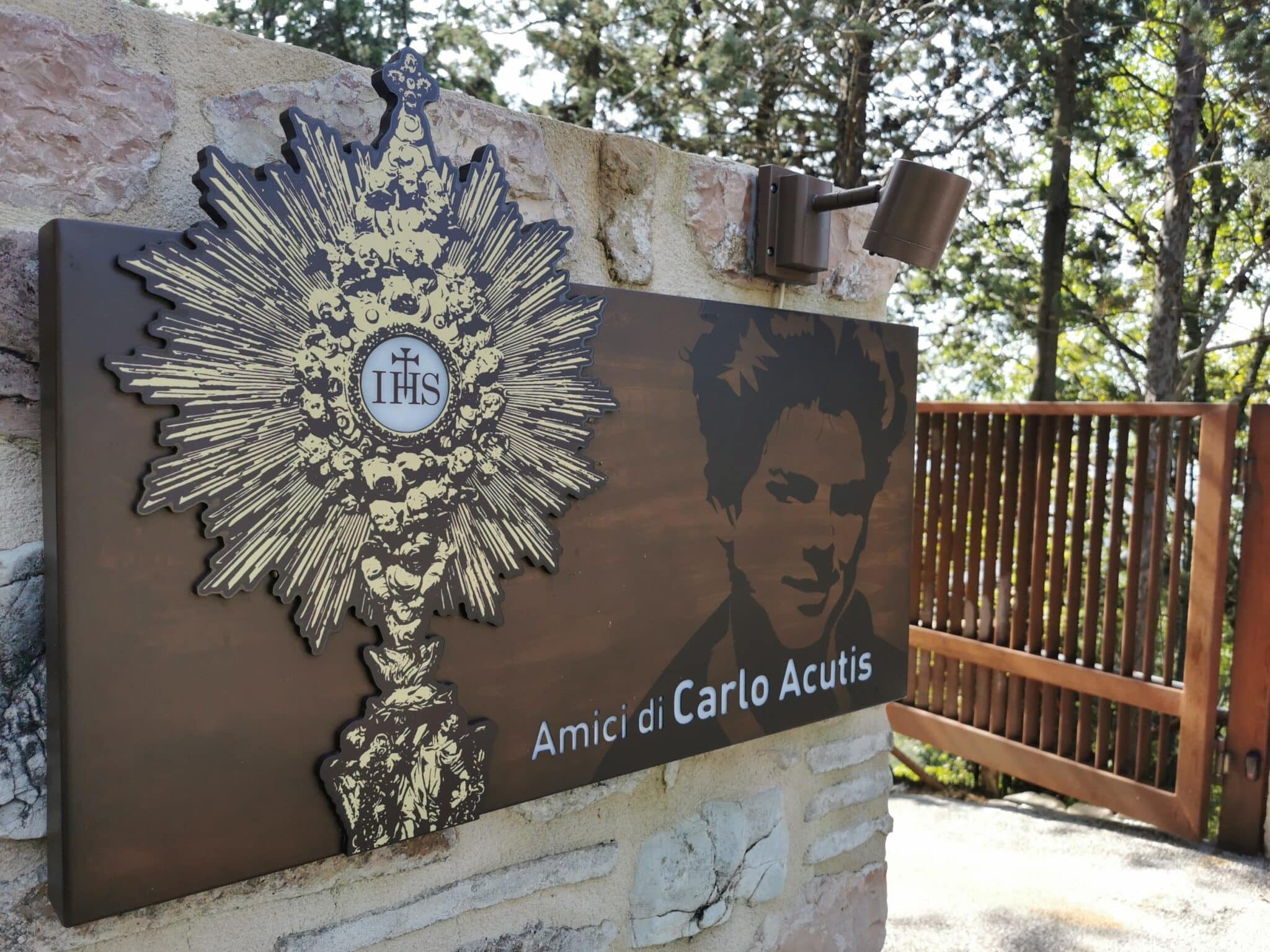 Images of Blessed Carlo Acutis and the Eucharist are seen outside the building of the Friends of Carlo Acutis association in Assisi, Italy, in this Oct. 9, 2020, file photo. The U.S. bishops have chosen Blessed Acutis as the patron of the first year of a three-year National Eucharistic Revival. The Italian teen had a great love of the Eucharist and used his technology skills to build an online database of eucharistic miracles around the world. (CNS photo/Junno Arocho Esteves)