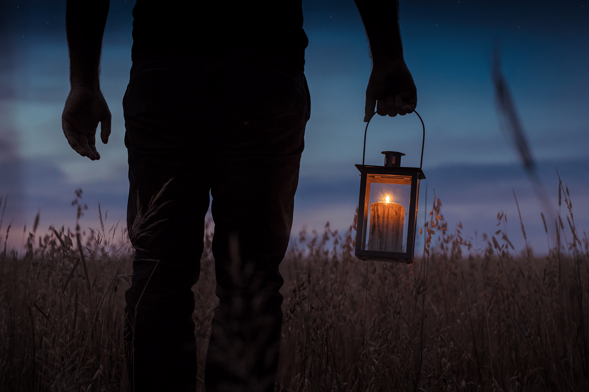 man holding a lantern