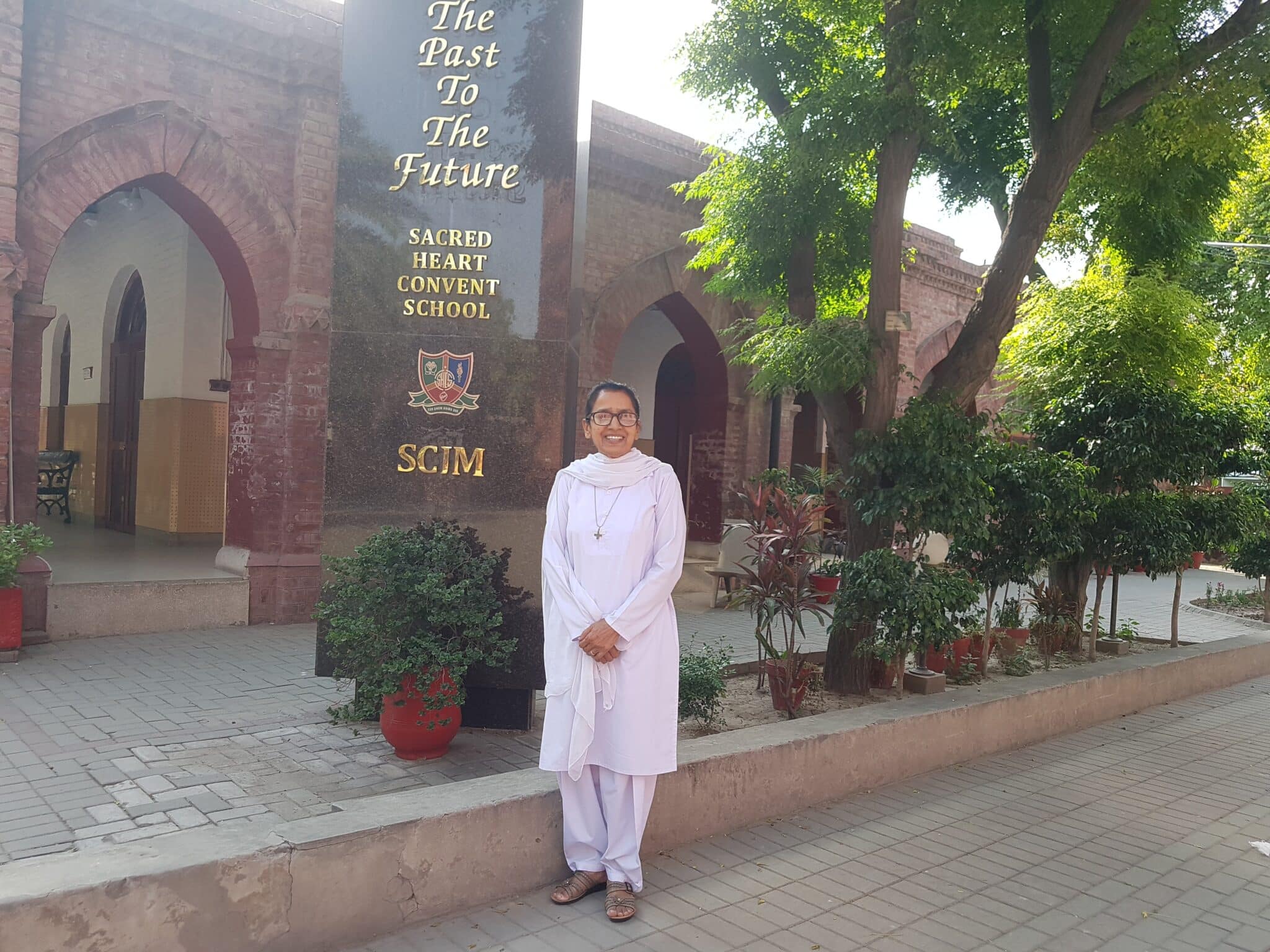 Sister Genevieve Ram Lal poses outside Sacred Heart Convent School in Lahore, Pakistan, May 15, 2023. A member of the Congregation of the Sisters of Charity of Jesus and Mary, Sister Ram Lal has been the national director of the Catholic Women's Organization since 2012. She and her organization, which she calls the "family," work to empower women in Pakistan. (OSV News photo/Kamran Chaudhry, Global Sisters Report)