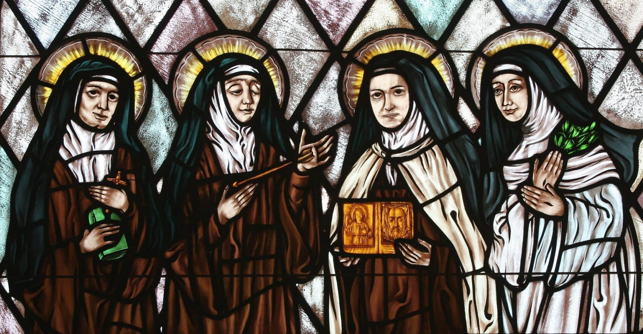 St. Therese of Lisieux is featured holding an image of the Holy Face in this stained glass depiction of beloved female saints in the church of St. Therese, Montauk, N.Y. Illustrated are Sts. Teresa Benedicta of the Cross, Theresa of Avila, Therese of Lisieux and Catherine of Siena. (OSV News photo/Gregory A. Shemitz)