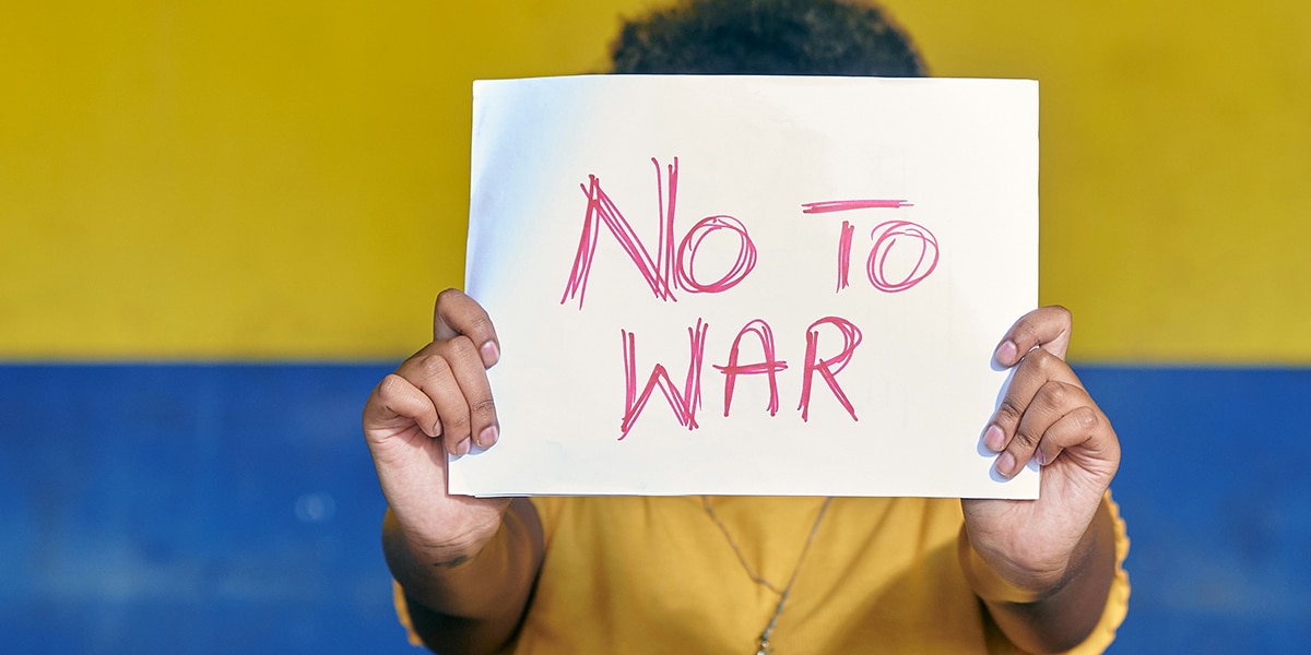 woman holding "no war" sign