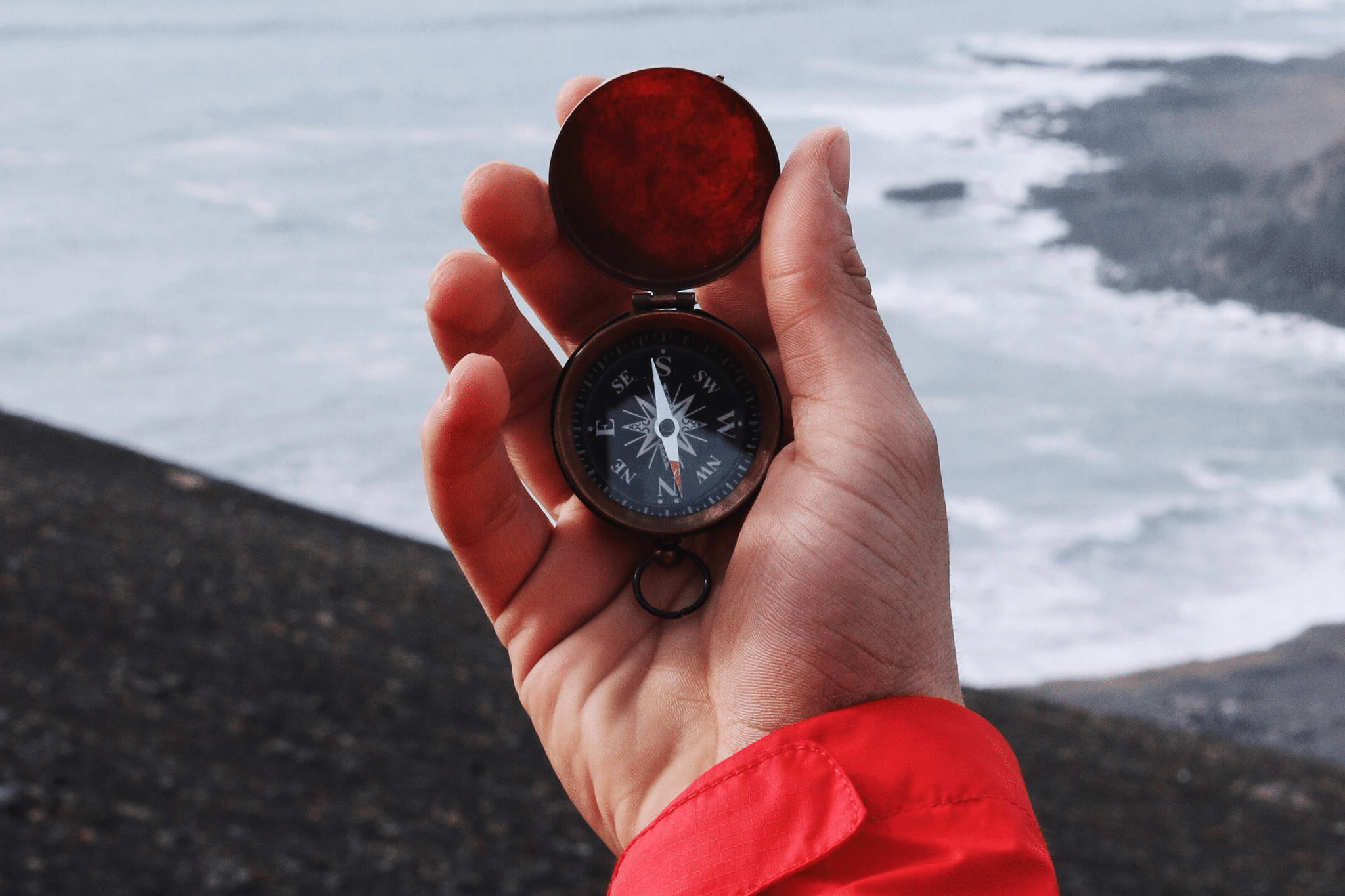 hand holding compass