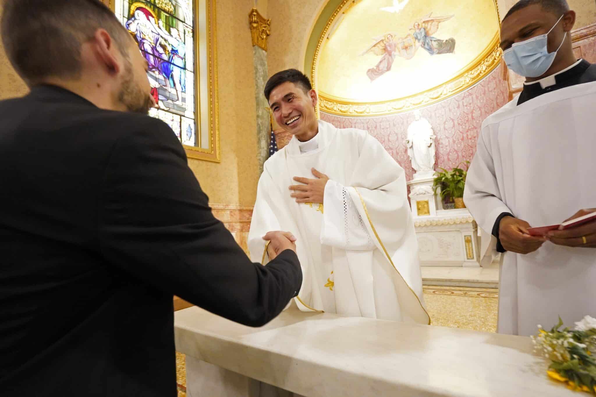 Father Chin Nguyen greets a well-wisher following his ordination to the priesthood June 5, 2021, at the Co-Cathedral of St. Joseph in Brooklyn, N.Y. Father Nguyen, who was born in Vietnam, was one of four men ordained by Bishop Nicholas DiMarzio of Brooklyn at the Mass. (OSV News photo/Gregory A. Shemitz)