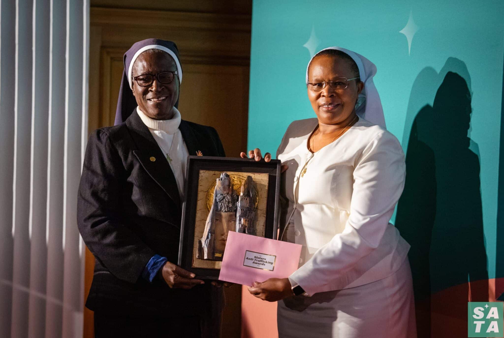 Sister Patricia Ebegbulem, a Sister of St. Louis from Nigeria, receives the Human Dignity Award from Sister Jane Wakahiu, a Little Sister of St. Francis of Assisi, at a London ceremony Oct. 31, 2023. Sister Wakahiu is associate vice president of the Conrad N. Hilton Foundation, a sponsor of the inaugural Sisters Anti-Trafficking Awards along with the Arise foundation and the International Union of Superiors General. (OSV News photo/courtesy Arise foundation)