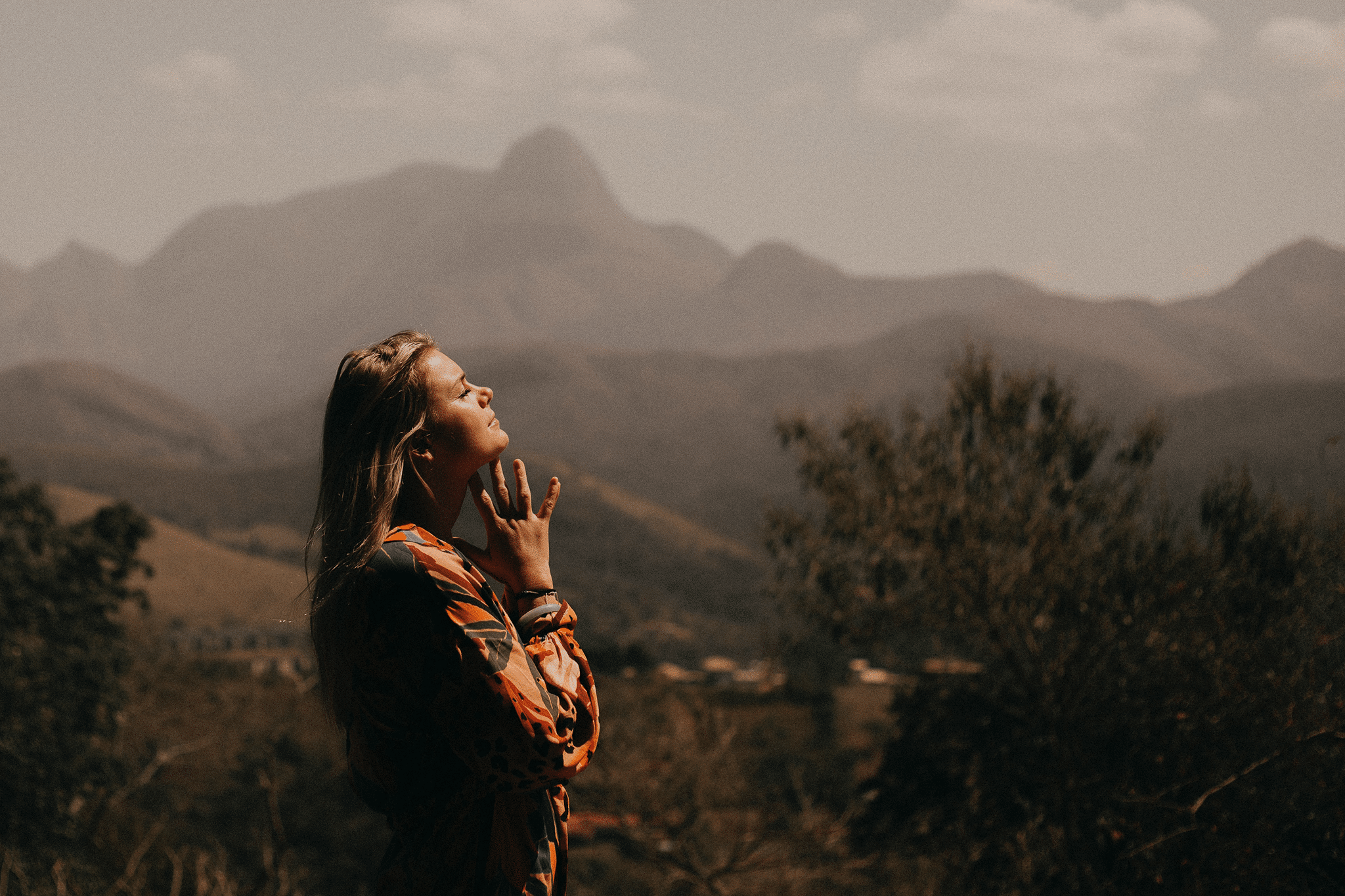 woman praying, looking up into the sky.