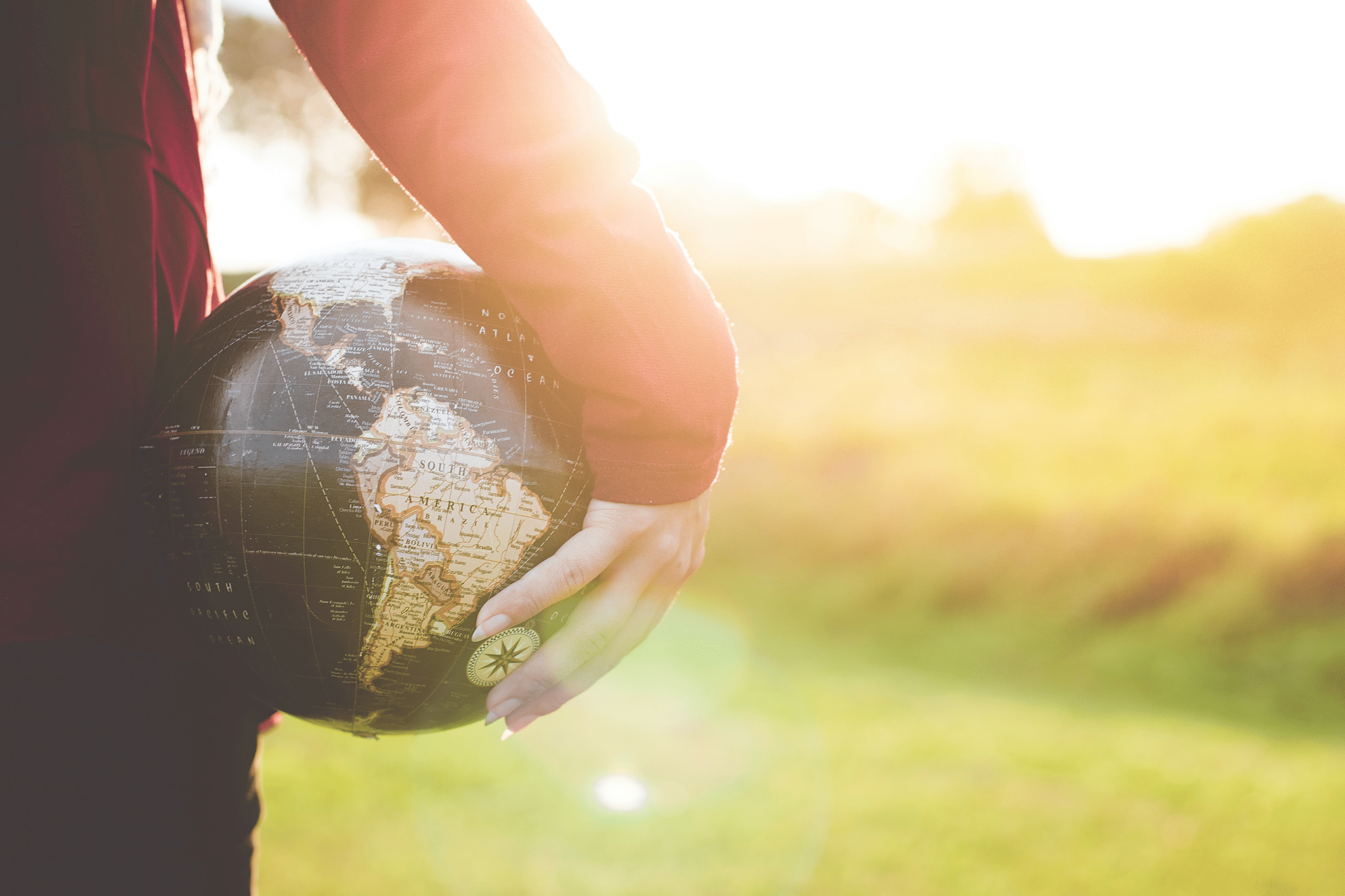 person holding globe