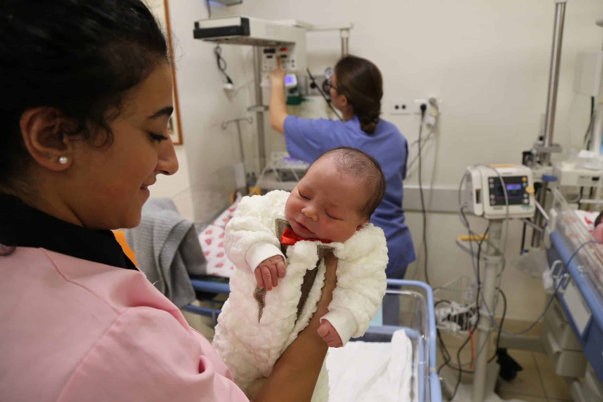 A woman is pictured in a file photo holding a newborn at Holy Land Family Hospital of Bethlehem in the West Bank. The hospital, located just 1,500 steps from the birthplace of Christ, is confronting significant challenges amid the ongoing war between Israel and Hamas in the Gaza Strip 45 miles away. (OSV News photo/courtesy HFH Foundation)