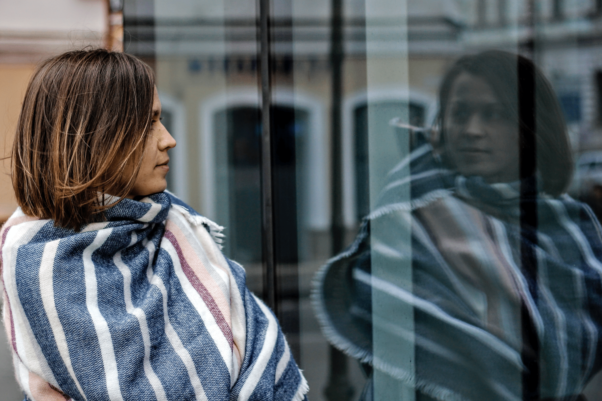 woman's reflection in a window