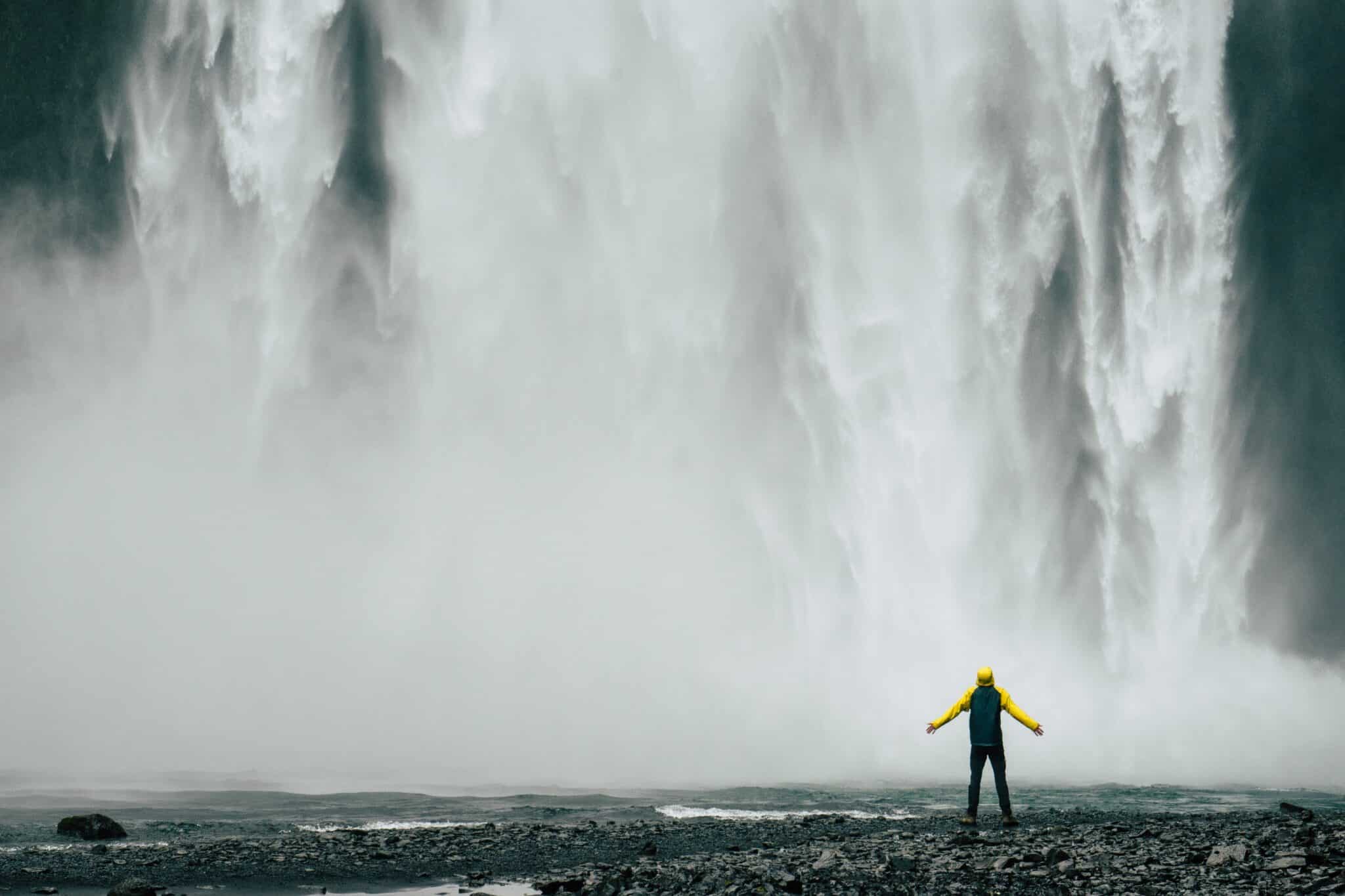 man standing by waterfall | Photo by Nick Decorte on Unsplash