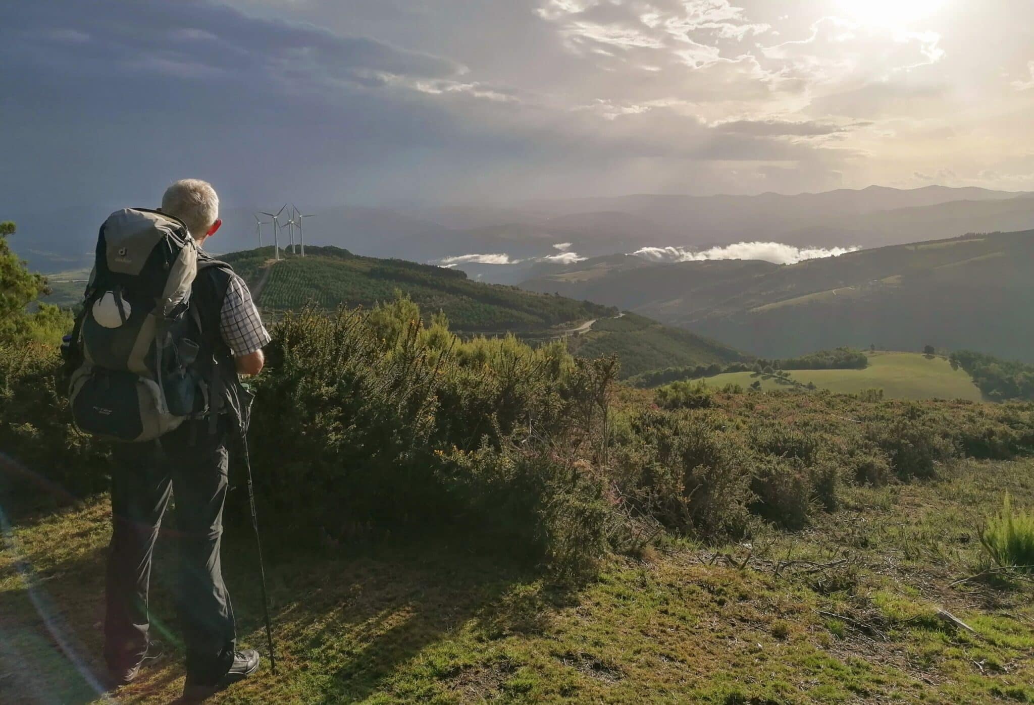A pilgrim stands on a mountain on Sept. 4, 2023, and looks into the vastness of the Galician landscape during his hike on the "Camino Primitivo" (one of the paths of the Camino de Santiago) in Spain. (OSV News photo/Jörg Meyrer, KNA)