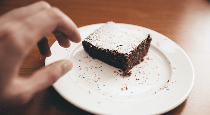 person tempted by a piece of cake.