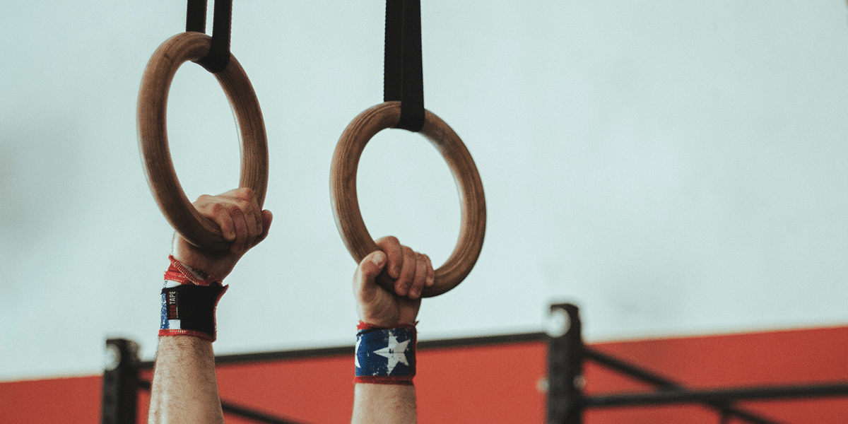 hands holding on to gymnastic rings
