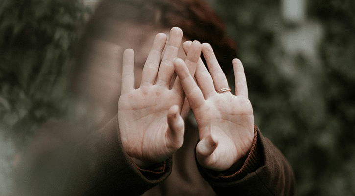 woman covering her eyes.