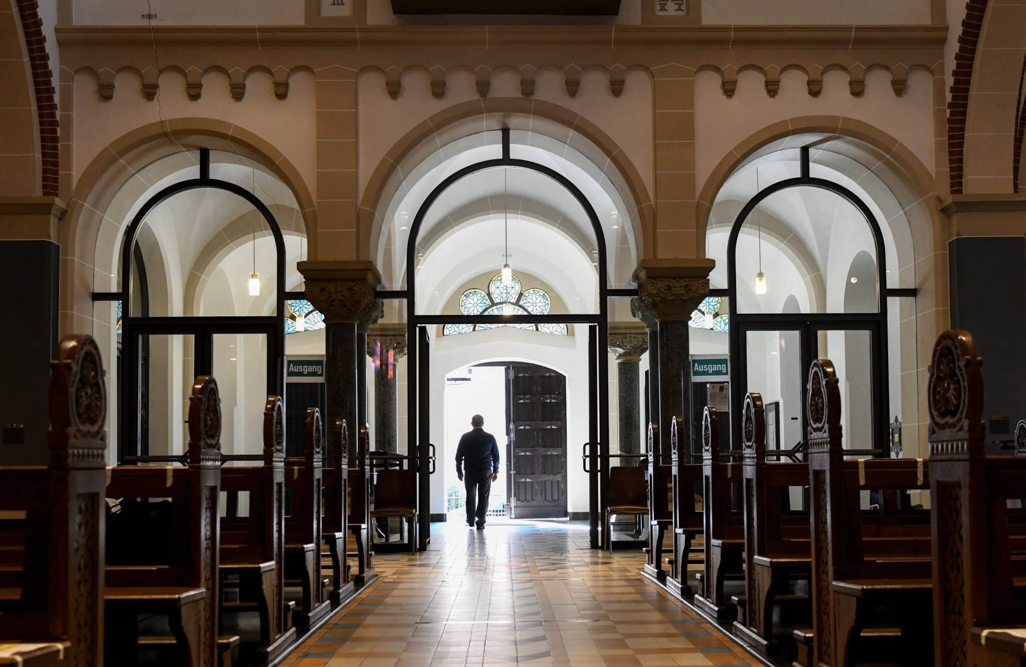 A man is seen in a file photo walking out of a church. Eden Invitation, an LBGTQ+ outreach based in St. Paul, Minn., recently announced it has trained its first "priest companions'' to accompany the organization's Hearth Groups, or local chapters, and be available for spiritual guidance, to administer the sacraments and to build community. Father Nathan Hall, a pastor in Lincoln, Neb., is among Eden Invitation's first priest companions. (OSV News photo/Harald Oppitz, KNA, CNS)