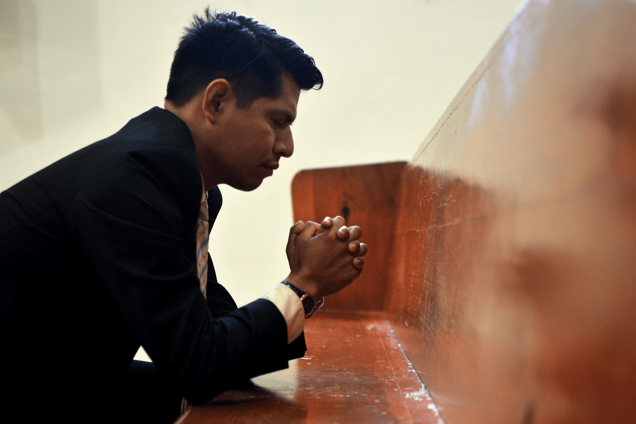 man kneeling in prayer