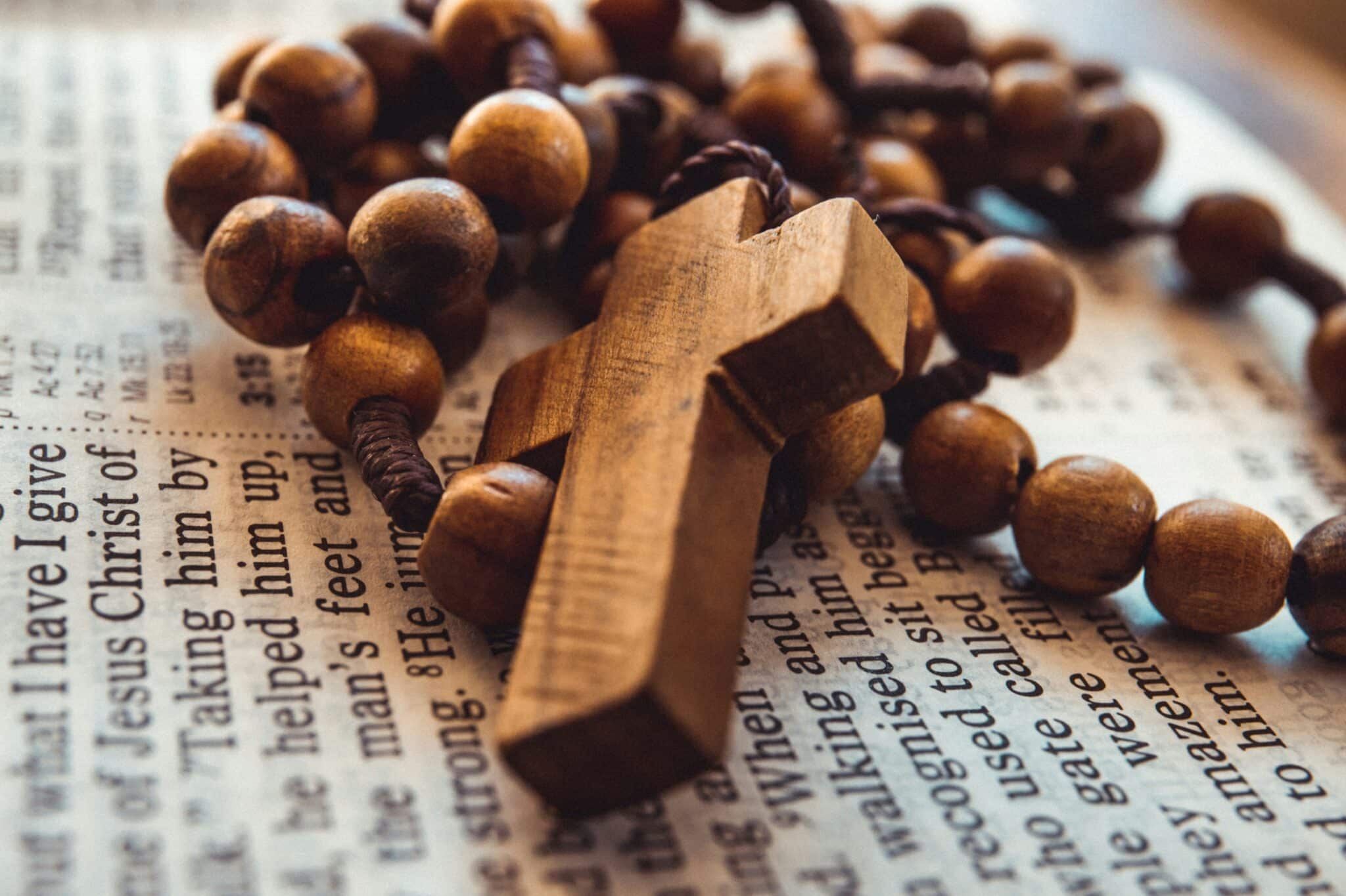 rosary on a bible | Photo by James Coleman on Unsplash