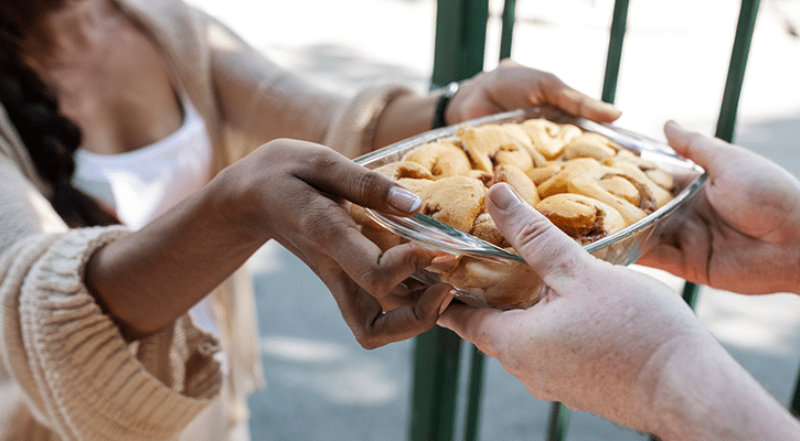 woman handing food to another woman