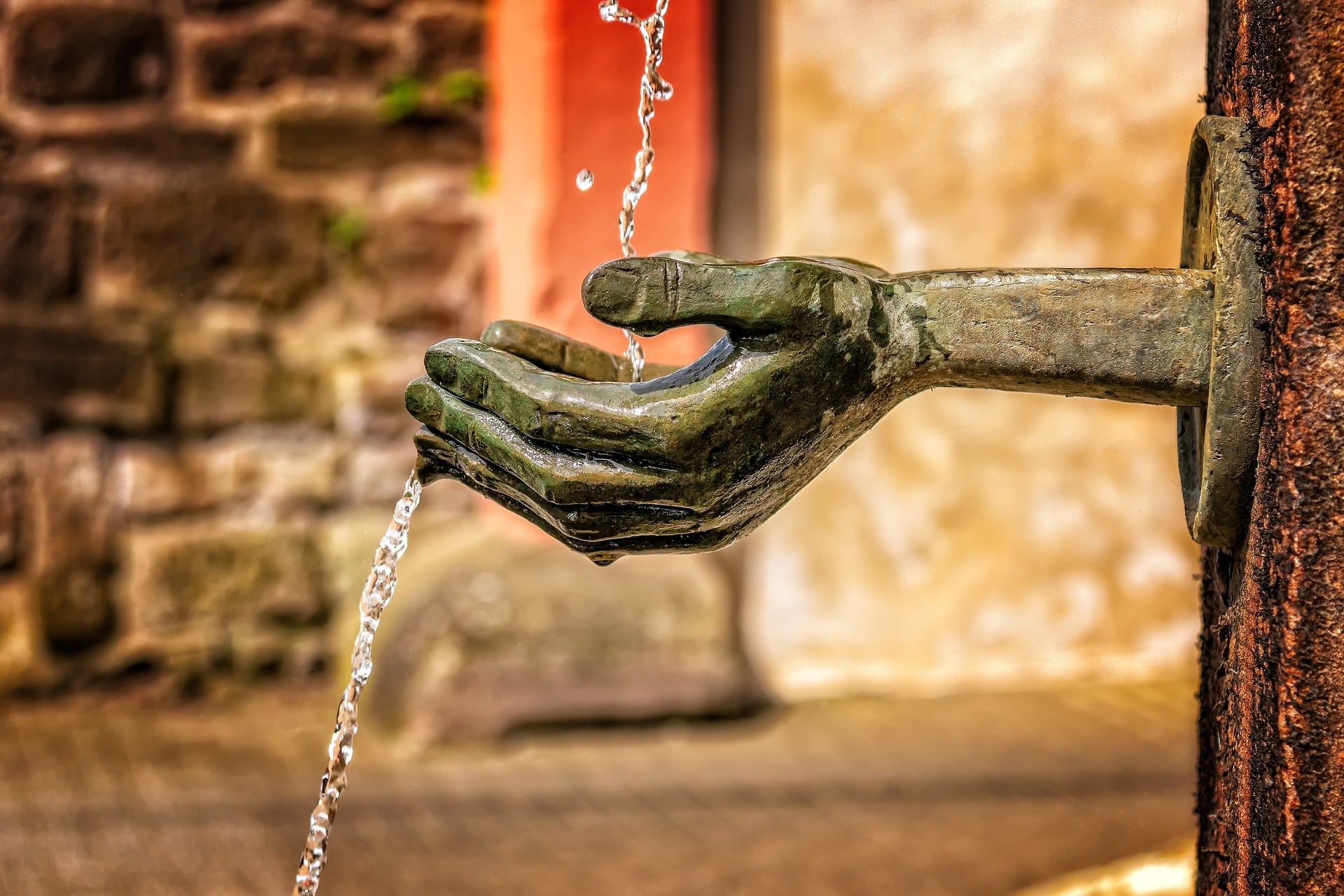 statue of a hand and water
