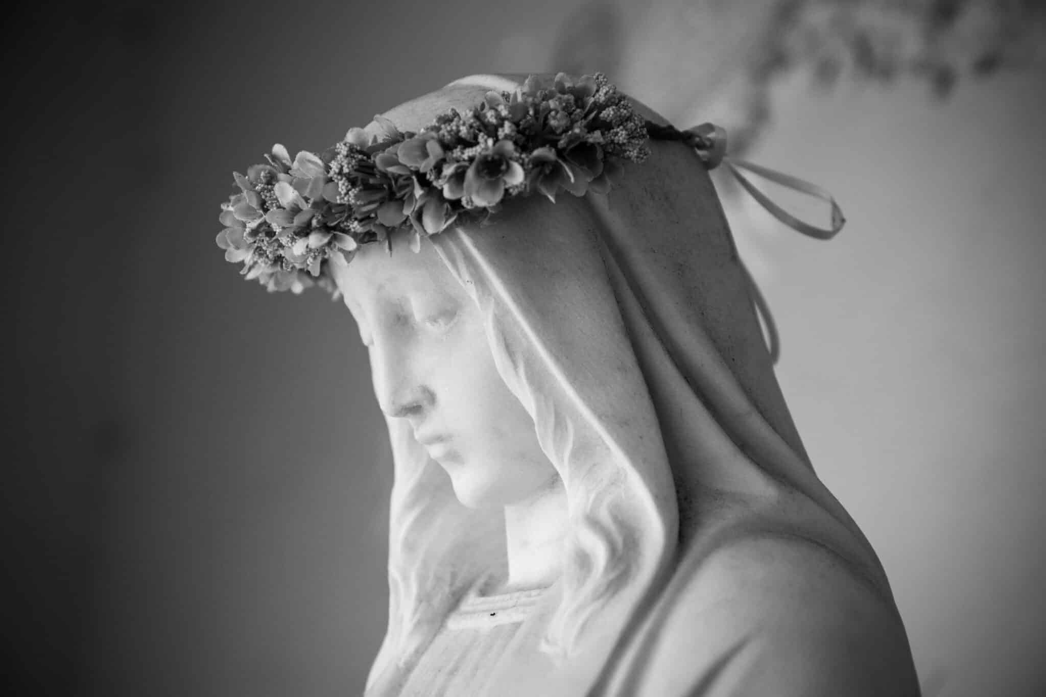 Mary statue with a crown of flowers | Photo by Marites Allen on Unsplash