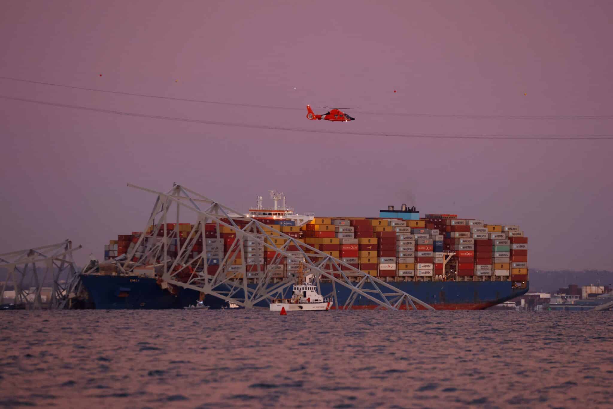 A U.S. Coast Guard helicopter hovers over the Dali cargo vessel March 26, 2024, after it crashed into the Francis Scott Key Bridge causing it to collapse in Baltimore. Archbishop William E. Lori of Baltimore and that city's officials have called for prayers as rescue efforts continue, following the early morning collapse of the bridge. (OSV News photo/Julia Nikhinson, Reuters)