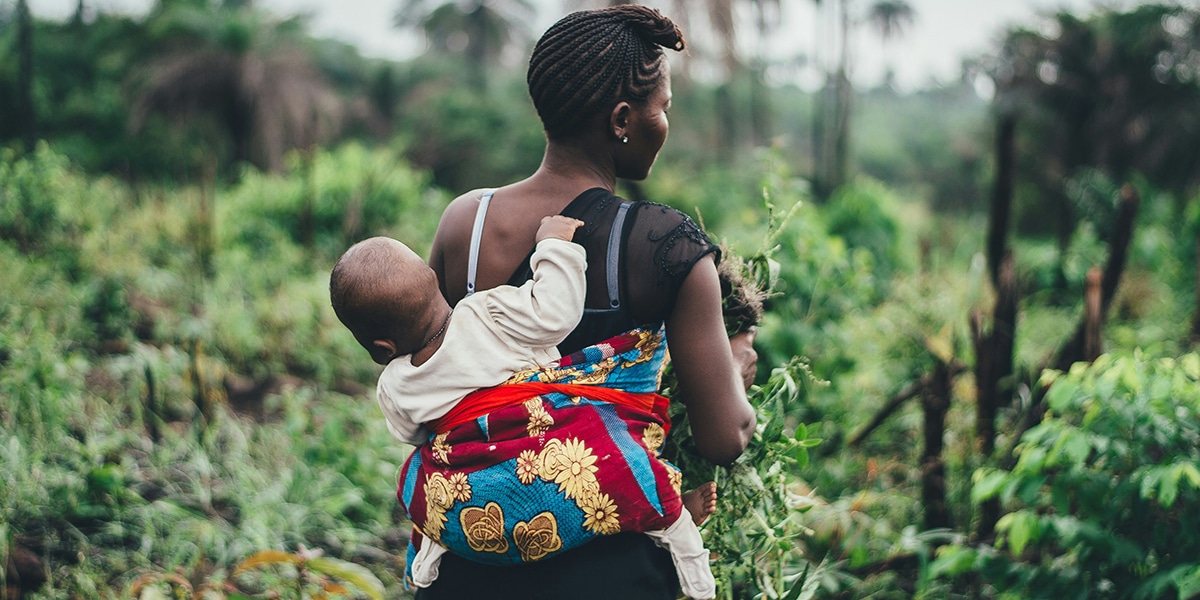 mom carrying child while working