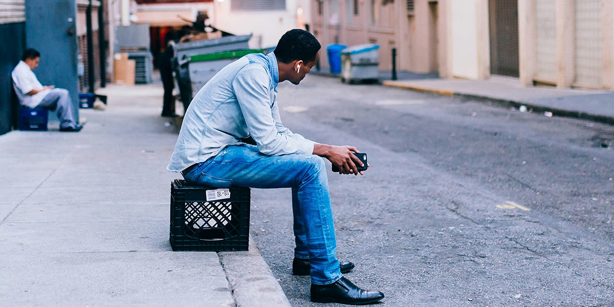 man sitting still n the pavement.