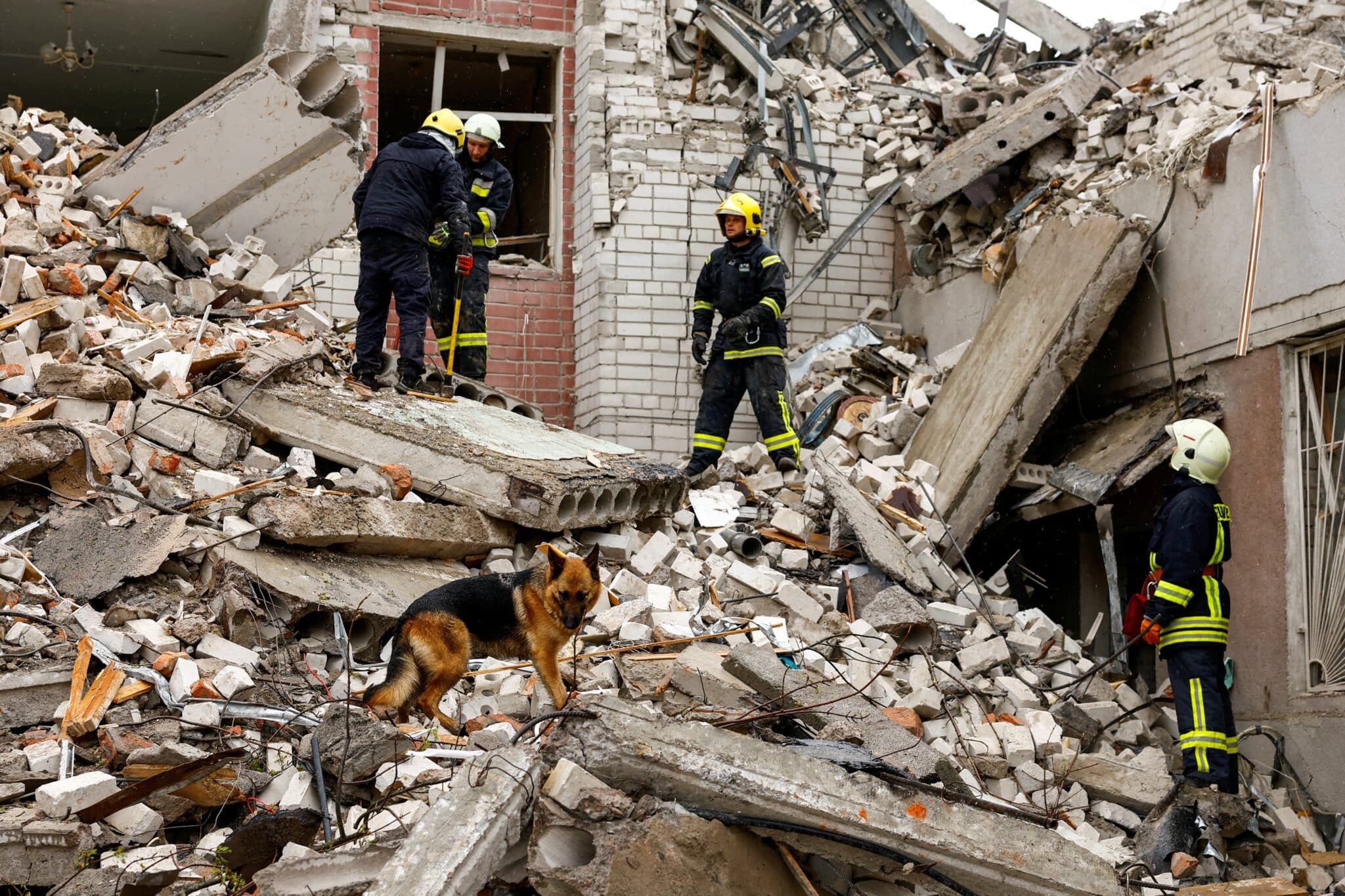 rescuers-in-ukraine-stand-on-rubble-from-collapsed-building-following-Russian-airstrike