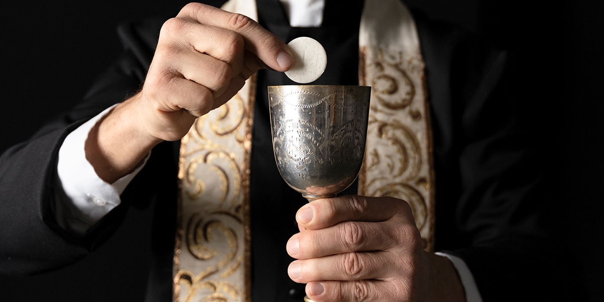 Priest holding waver and wine