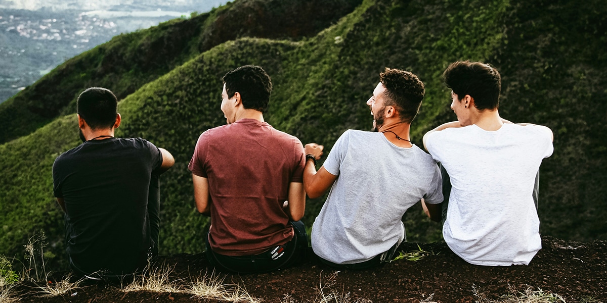 four guys talking, having fun together