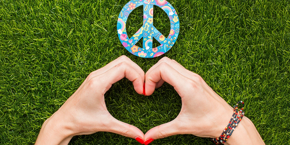 hands showing heart sign next to a peace symbol