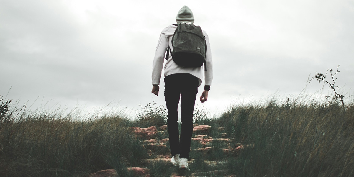 woman hiking up a hill